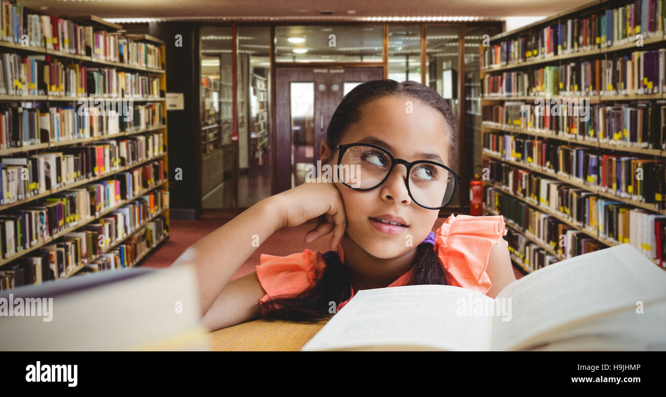 Immagine composita della giovane ragazza sogno ad occhi aperti da libro a tavola Foto Stock