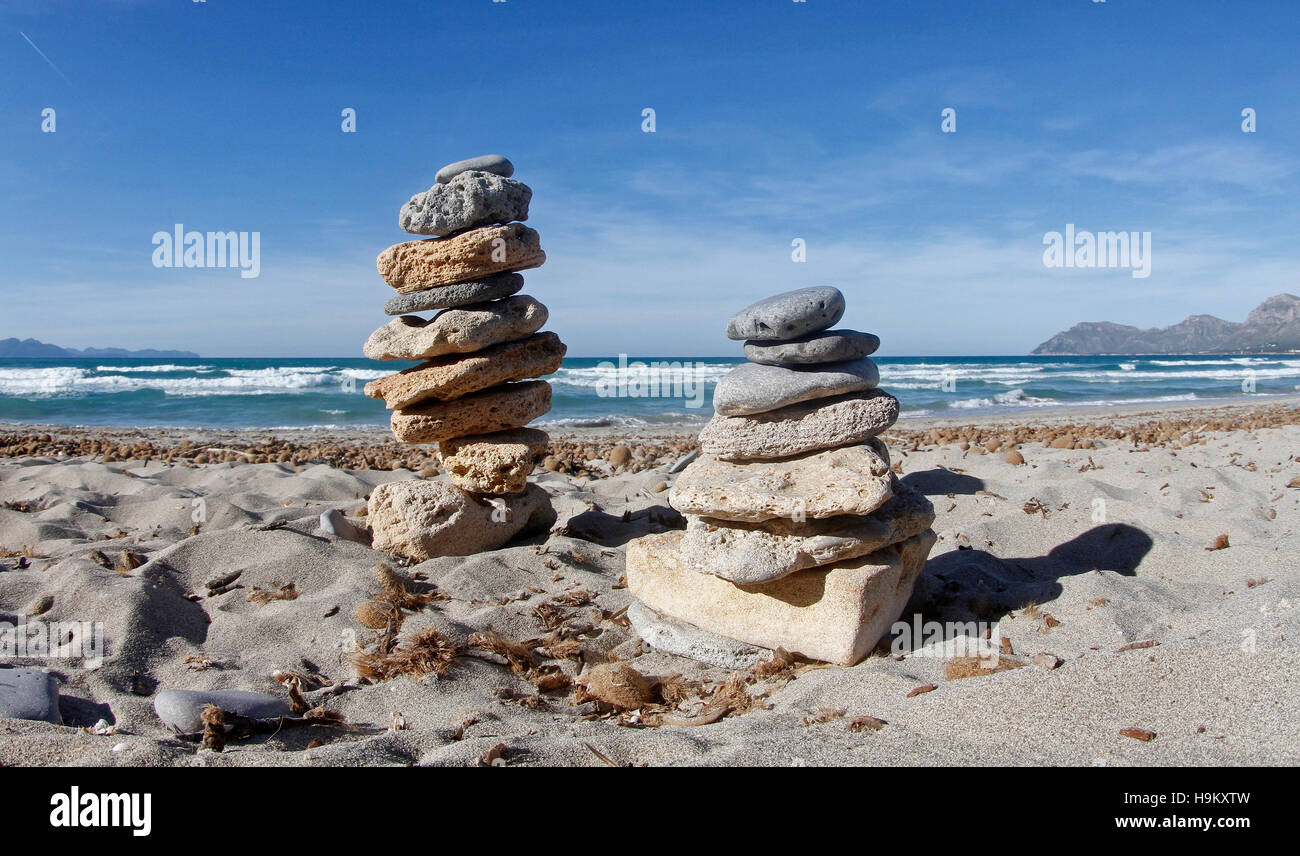 Pietre Zen torre in una spiaggia con il blu del cielo e mare calmo. In un giorno di estate in Maiorca nelle Isole Baleari di Spagna. Foto Stock