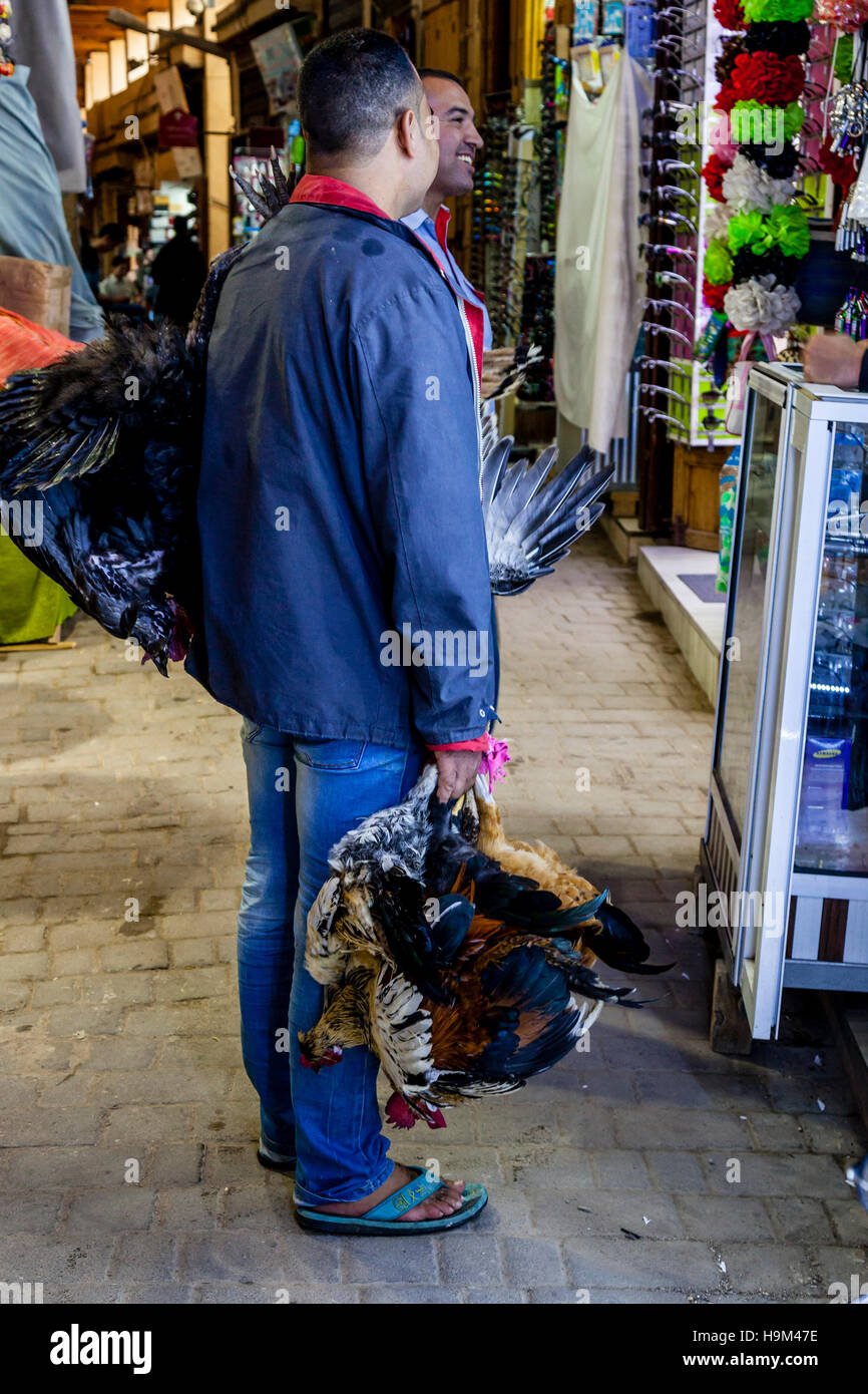 Due uomini Chat con un bottegaio nella Medina di Fez el Bali, Fez, in Marocco Foto Stock