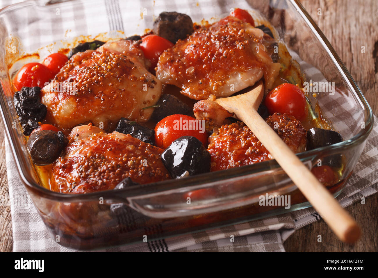 Il cibo gustoso: coscia di pollo al forno con pomodori e funghi selvatici da vicino in una teglia sul tavolo orizzontale. Foto Stock