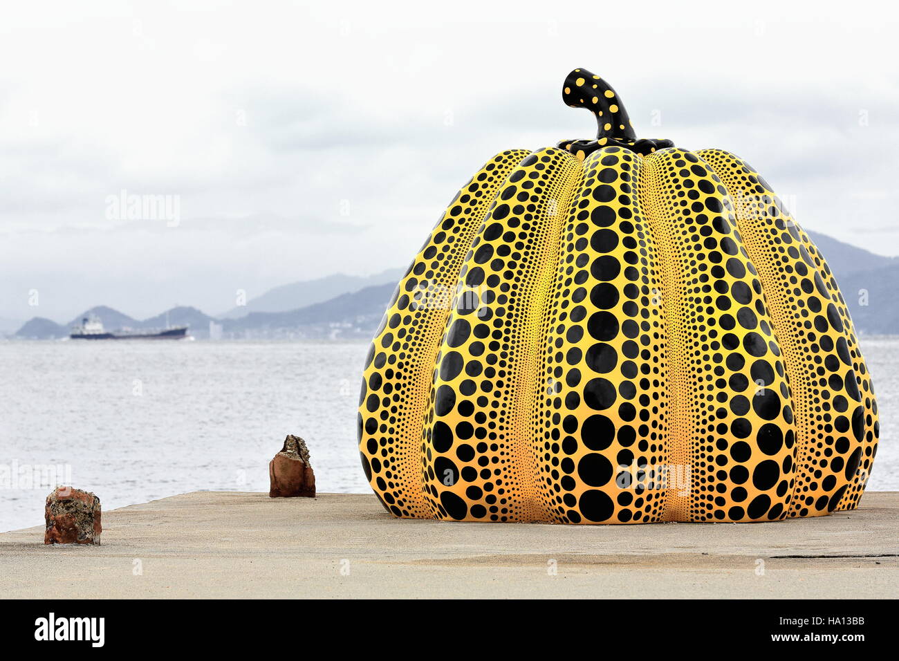 Naoshima, Japan-October 19, 2013: isola di Naoshima espone diverse opere all aria aperta tra di loro Yayoi Kusama gialla della scultura di zucca. Foto Stock