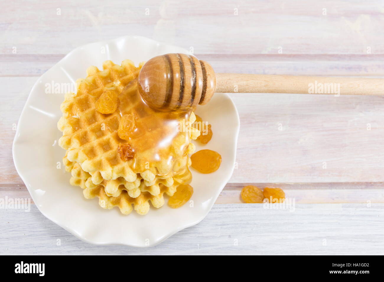 Cotta golden waffle cookies e il dolce miele Foto Stock