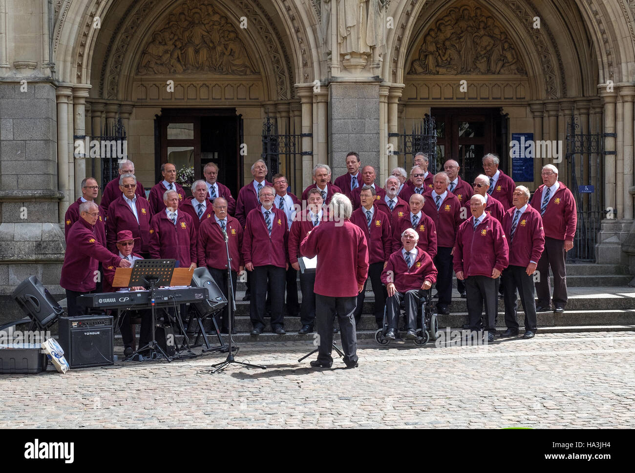 Truro coro di sole voci maschili di eseguire al di fuori della cattedrale di Truro, Cornwall, Regno Unito Foto Stock