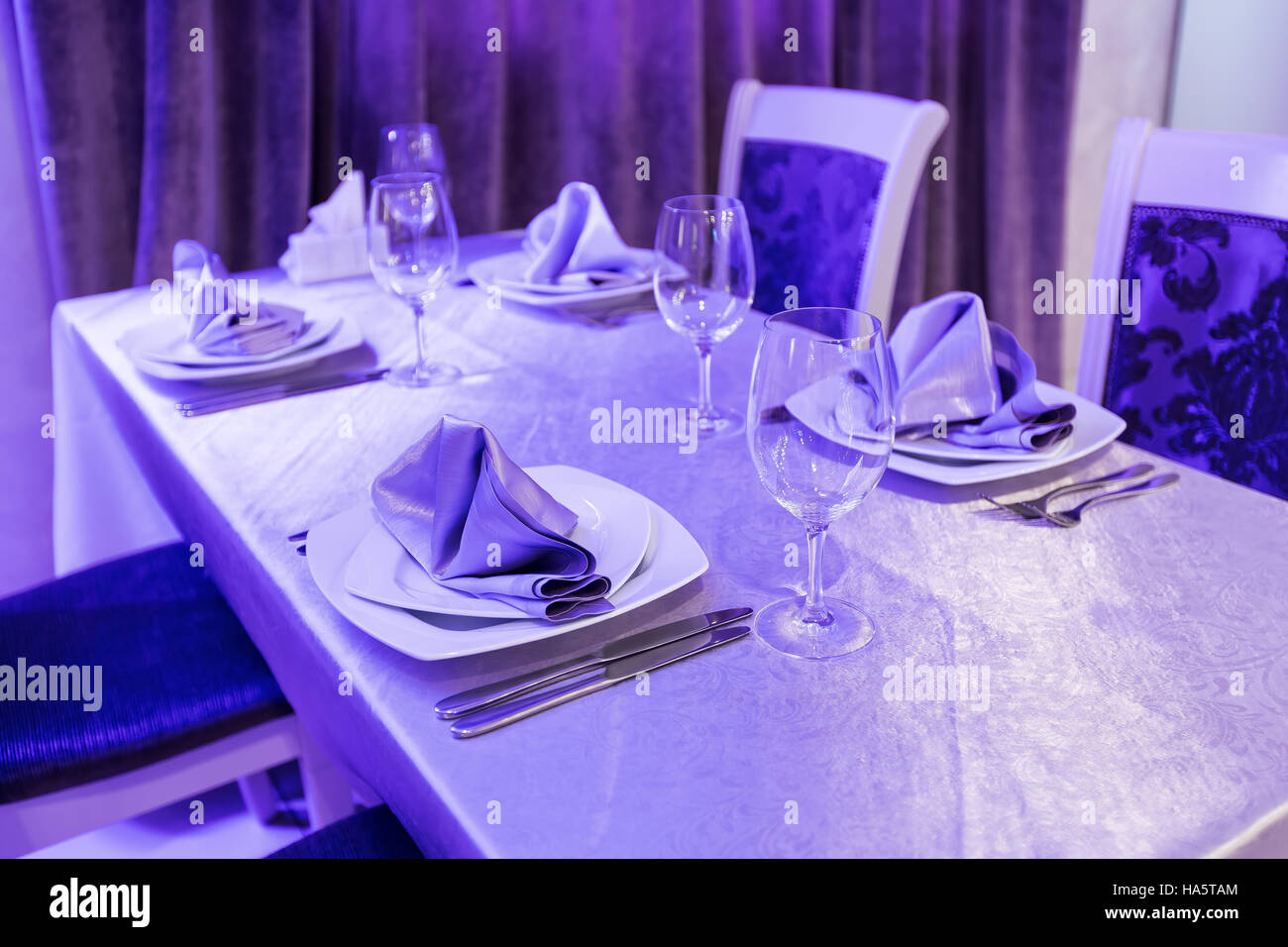 Svuotare i bicchieri e piatti insieme in un interno nuovo lussuoso ristorante con tavoli coperti Foto Stock