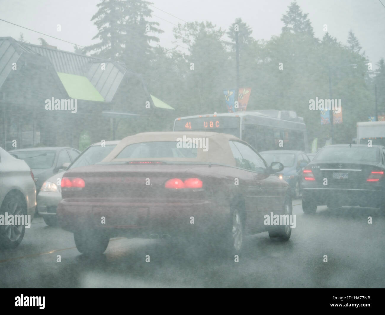 Auto il traffico sul bus di piovere wet weather scarsa visibilità la guida la strada affollata strada carreggiata Vancouver Canada Foto Stock