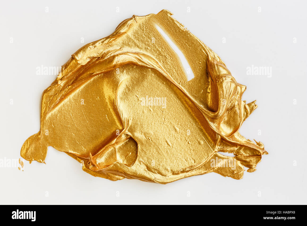 Oro vernice acrilica su sfondo bianco Foto Stock