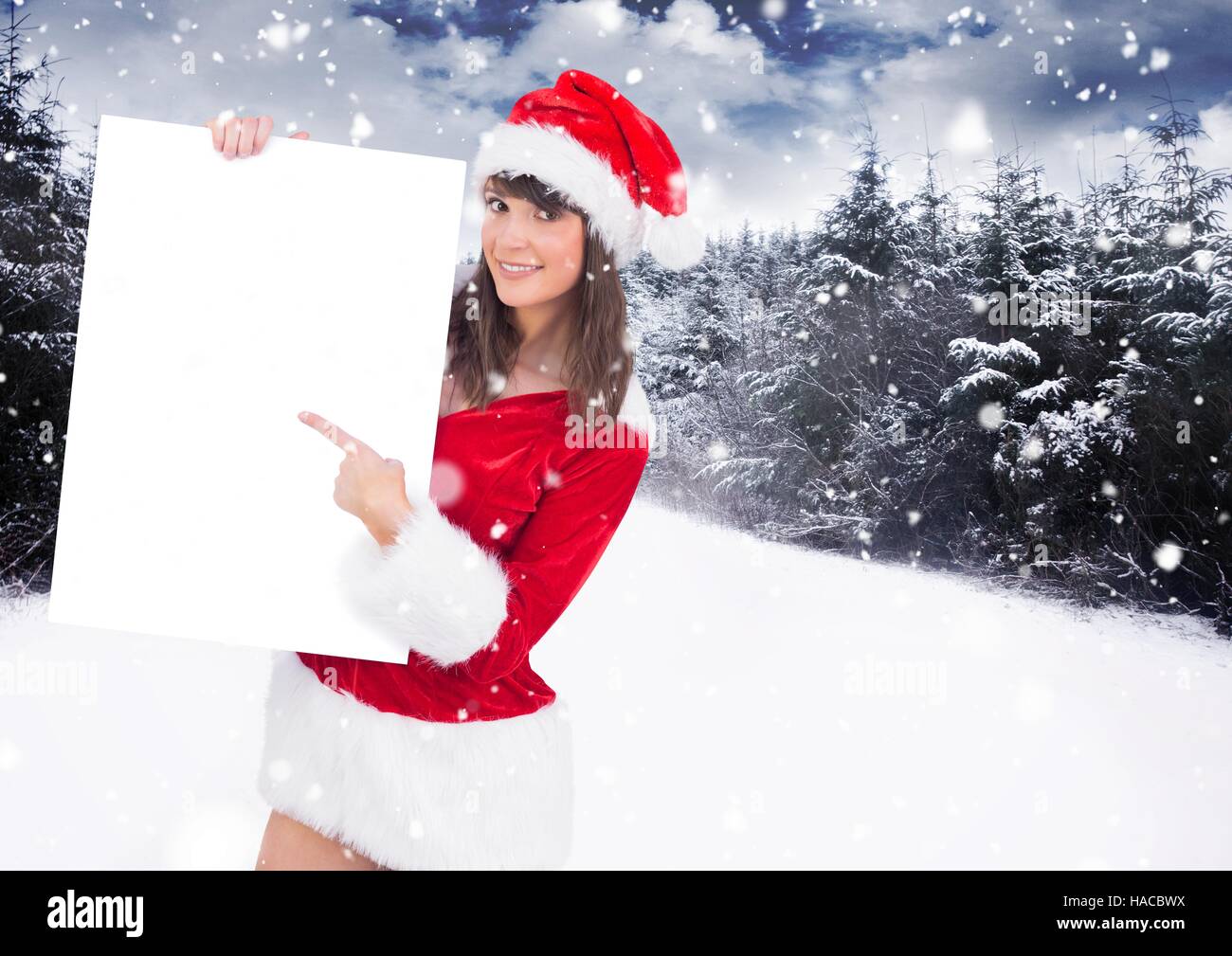 La donna a santa hat puntando alla targhetta vuota Foto Stock