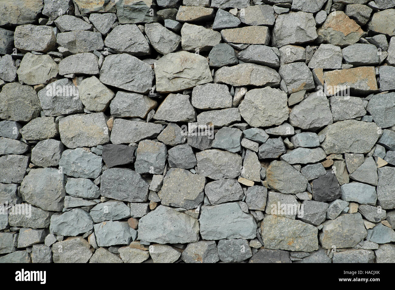 Muro di pietra naturale di sfondo - parete di macerie Foto Stock