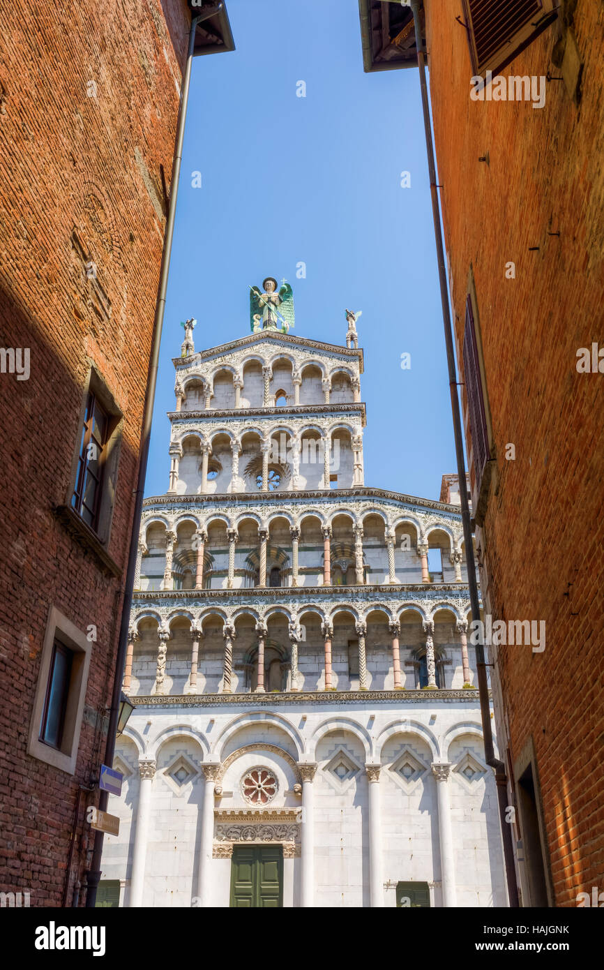 Vista attraverso un vicolo sulla chiesa di San Michele in Foro a Lucca, Italia Foto Stock