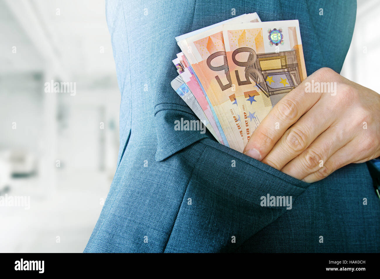 Concetto di corruzione, l uomo mettere il denaro in una tasca della giacca Foto Stock