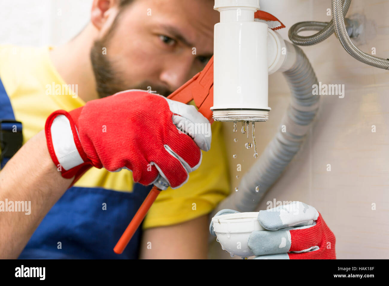 Plumber che fissa il sifone lavello in cucina o in bagno Foto Stock