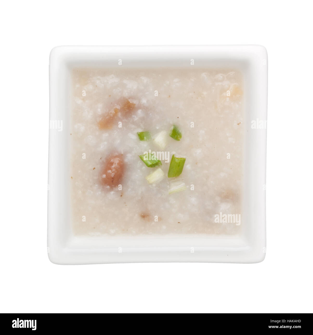 Riso congee cinesi in un recipiente quadrato isolato su sfondo bianco Foto Stock