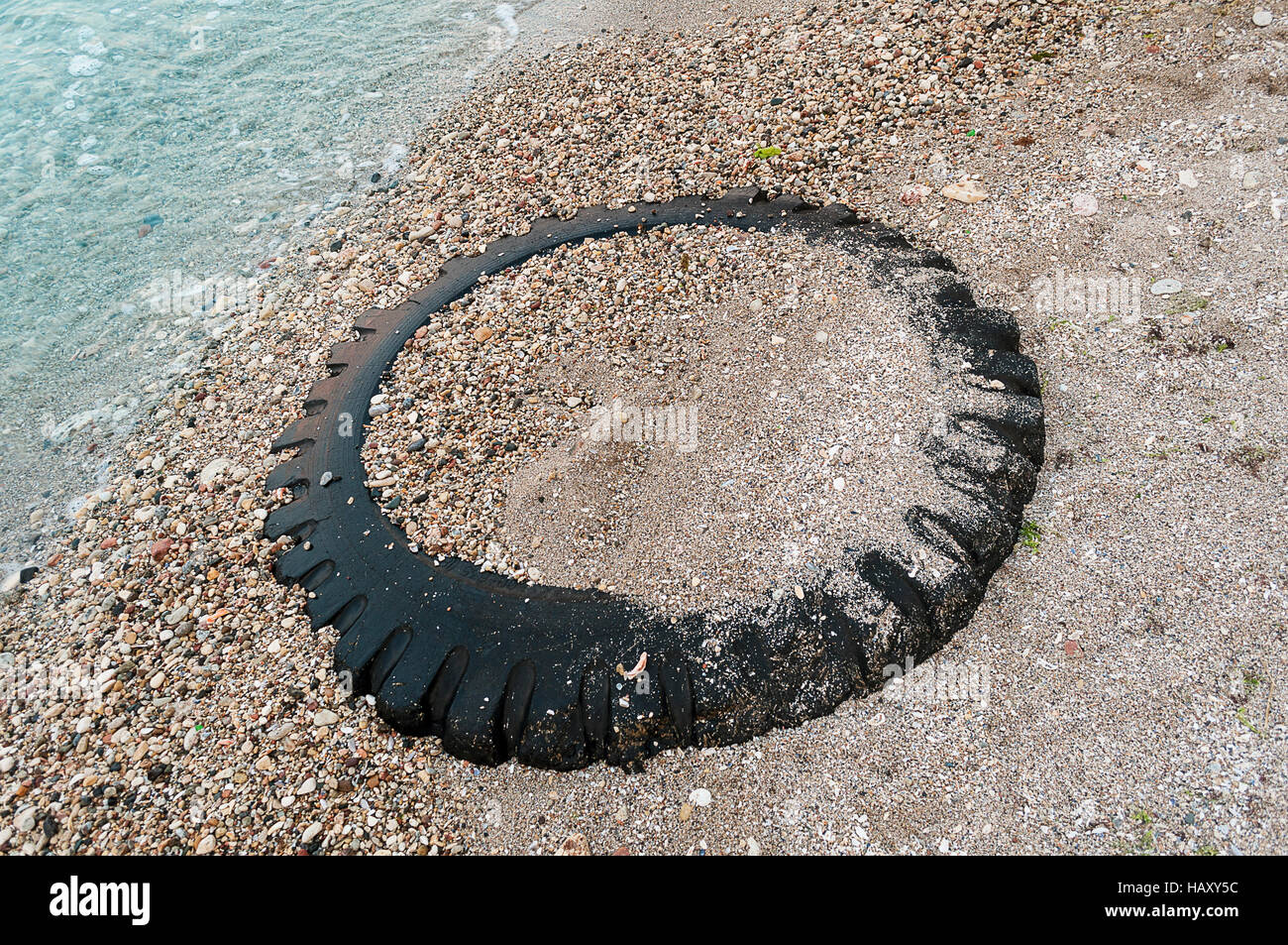 Ruota del trattore sepolto nella sabbia sulla spiaggia Foto Stock