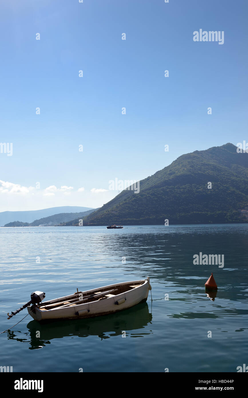 Piccola barca sulla banchina a liscia la superficie del mare vicino a Perast, Kotor Bay, Montenegro Foto Stock