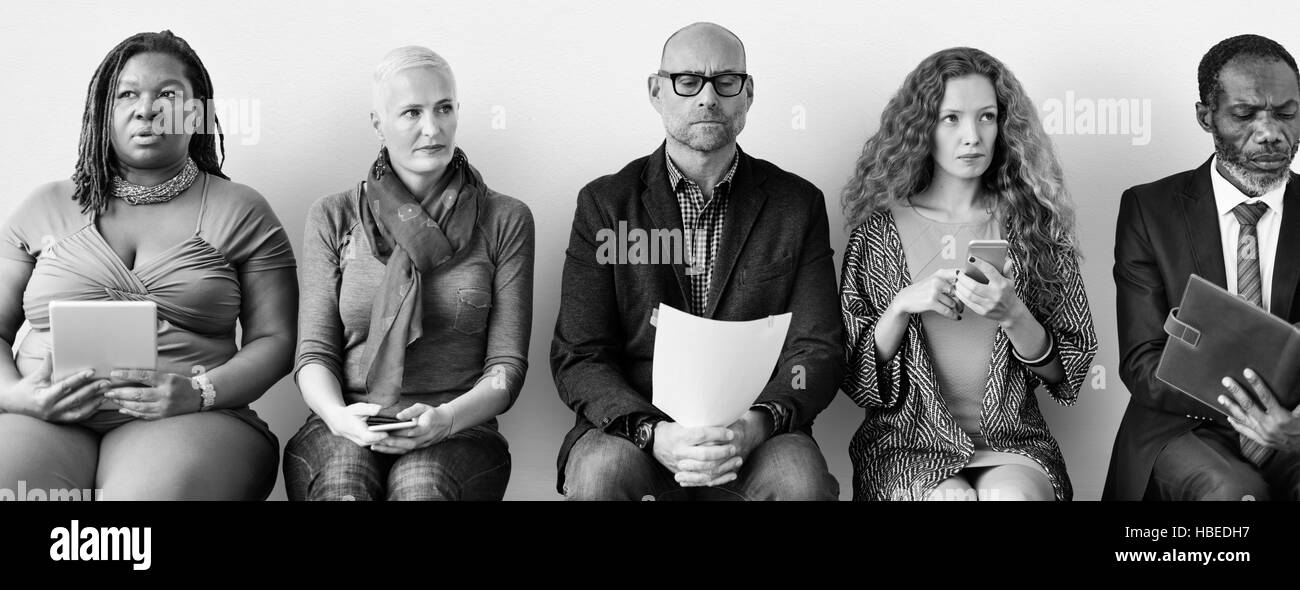 Diversi gruppi di persone in comunità seduta in attesa della nozione Foto Stock