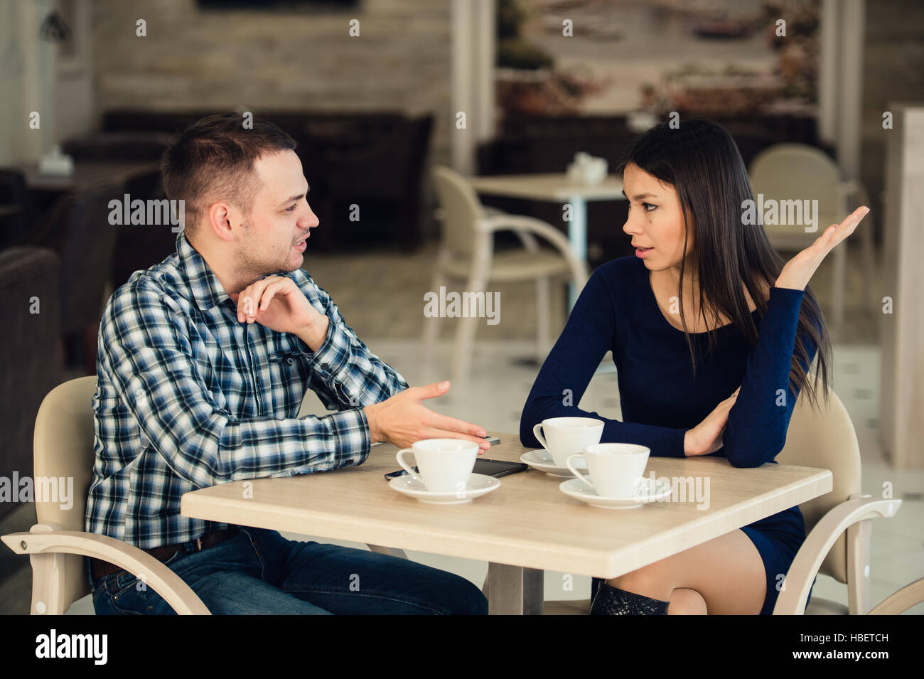 Coppia giovane sostenendo in una caffetteria. Problemi di relazione. Foto Stock