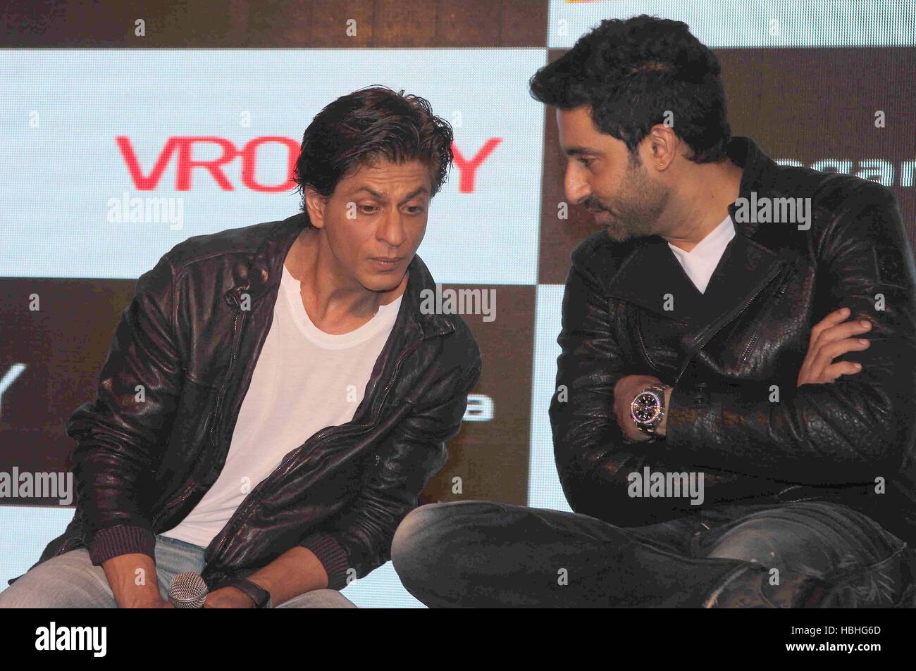 Abhishek Bachchan con l'attore Bollywood Shah Rukh Khan, maglietta bianca, giacca nera, al film Happy New Year evento a Mumbai, India Foto Stock