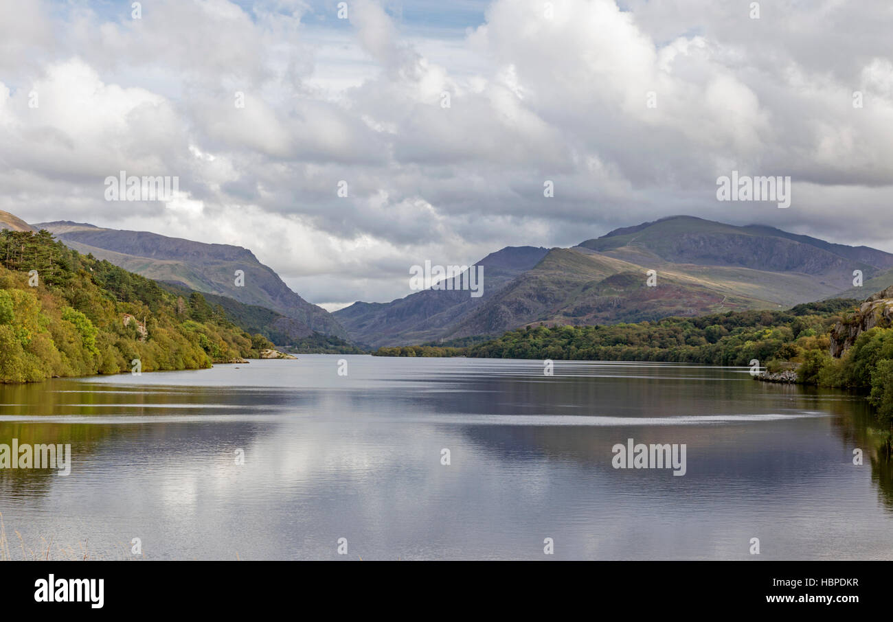 Llyn Padarn Lake nei pressi del villaggio di Llanberis e le lontane Snowdon massiccio, Parco Nazionale di Snowdonia, Gwynedd, Galles del Nord, Regno Unito Foto Stock