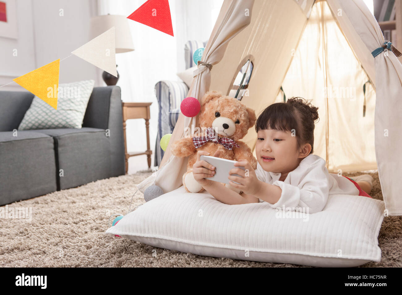 Sorridente ragazza che gioca con Teddy bear Foto Stock