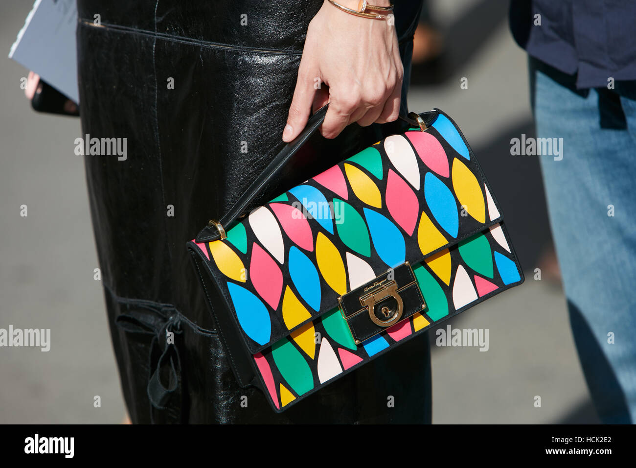 Donna con Ferragamo bag in rosa, blu, verde, giallo sacco prima Salvatore Ferragamo fashion show, la Settimana della Moda Milanese street. Foto Stock