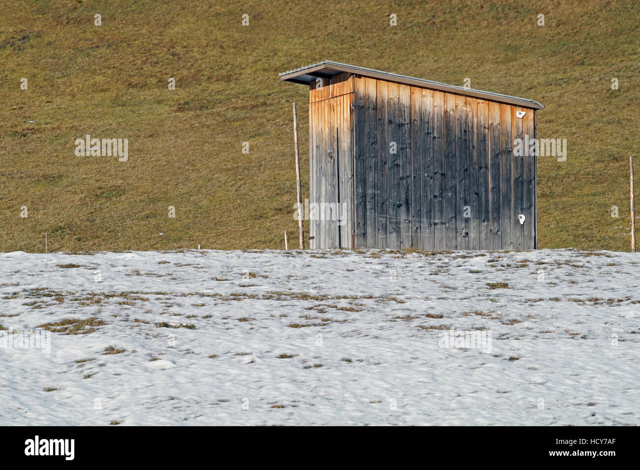 Abbandonato tettoia in legno in coperta di neve villaggio nel giorno di inverno Foto Stock