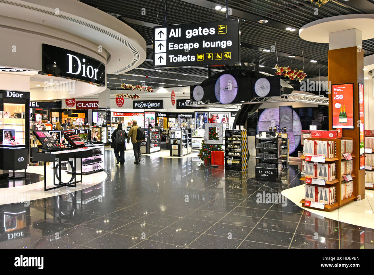 L'edificio del terminal dell'aeroporto di Stansted per lo shopping dei profumi per Londra Inghilterra Regno Unito dove i passeggeri camminano per raggiungere la lounge delle partenze Foto Stock