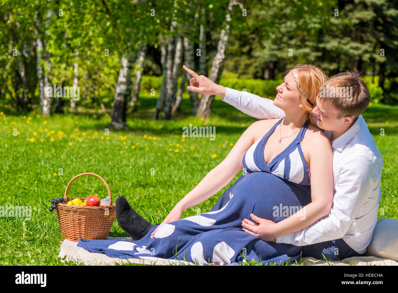 Bella coppia Giovane in previsione di un bambino, poggiano su un picnic nel parco Foto Stock