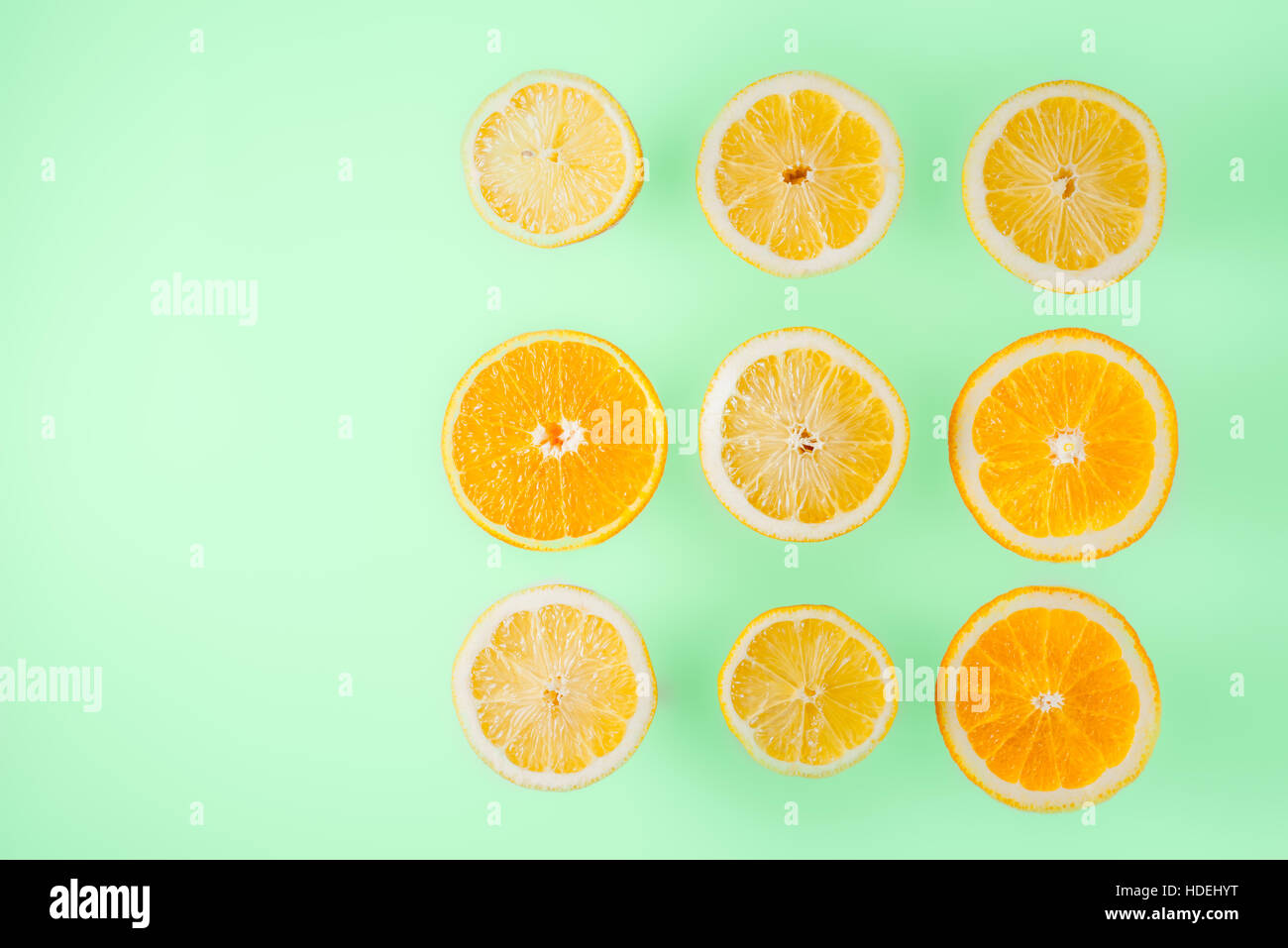 Limone e fettine di arancia sul fondo azzurro vista superiore Foto Stock