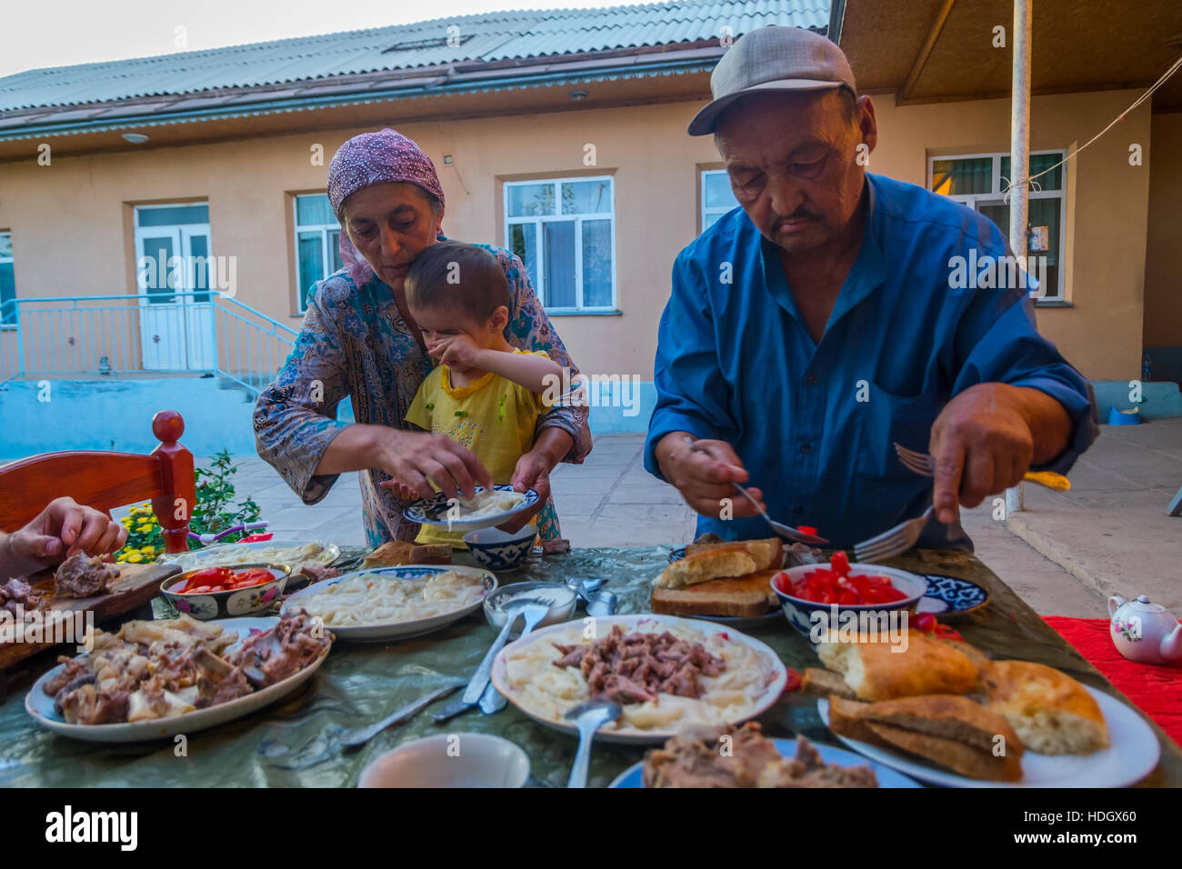TURBAT, Kazakistan - 21 Luglio: famiglia kazako mangiare tipico piatto beshbarmak fatto di carne di cavallo e le tagliatelle. Luglio 2016 Foto Stock