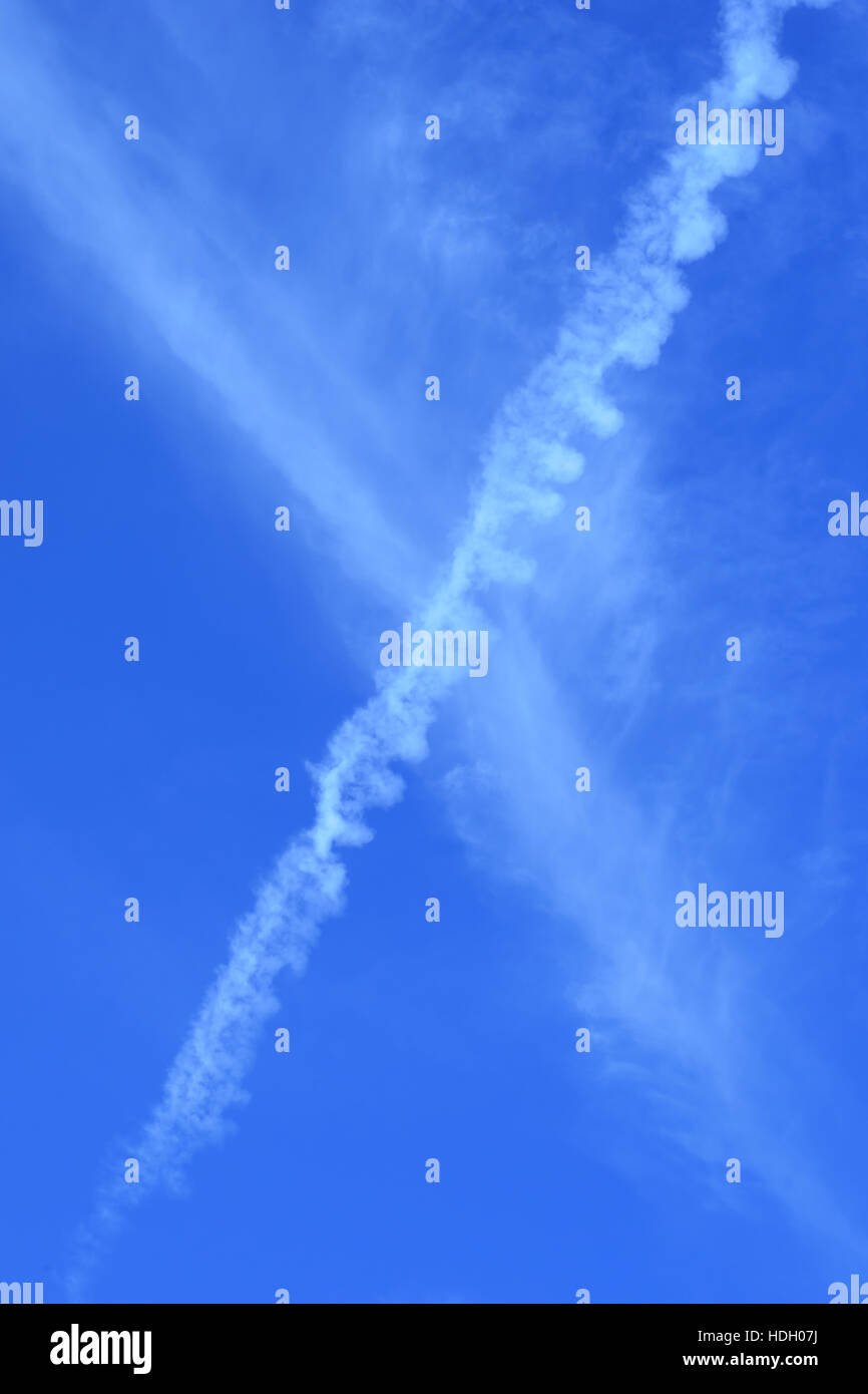 Contrail del velivolo sul cielo blu - verticale - Ritratto Foto Stock