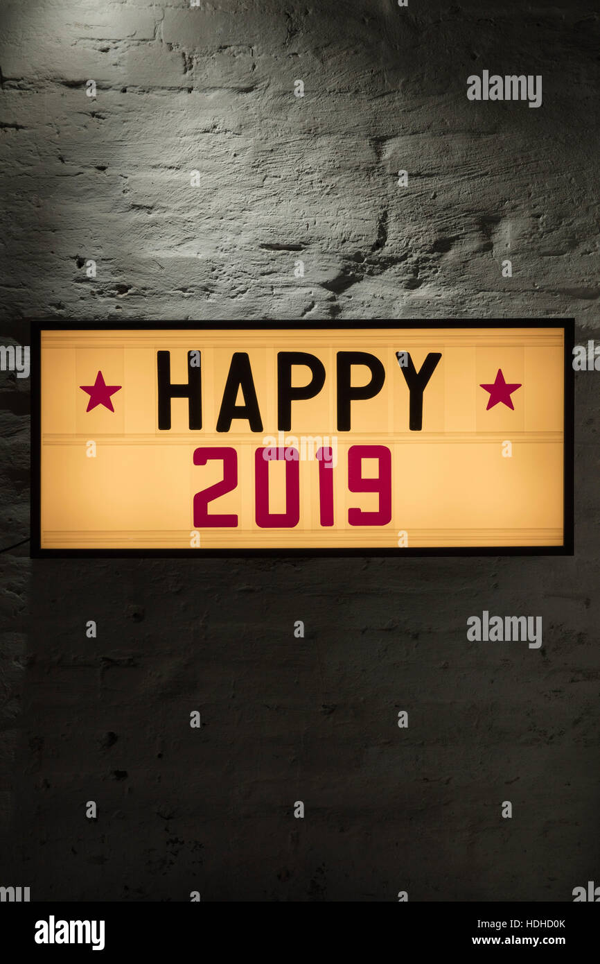 Close-up di Felice 2019 cartello contro il muro grigio Foto Stock