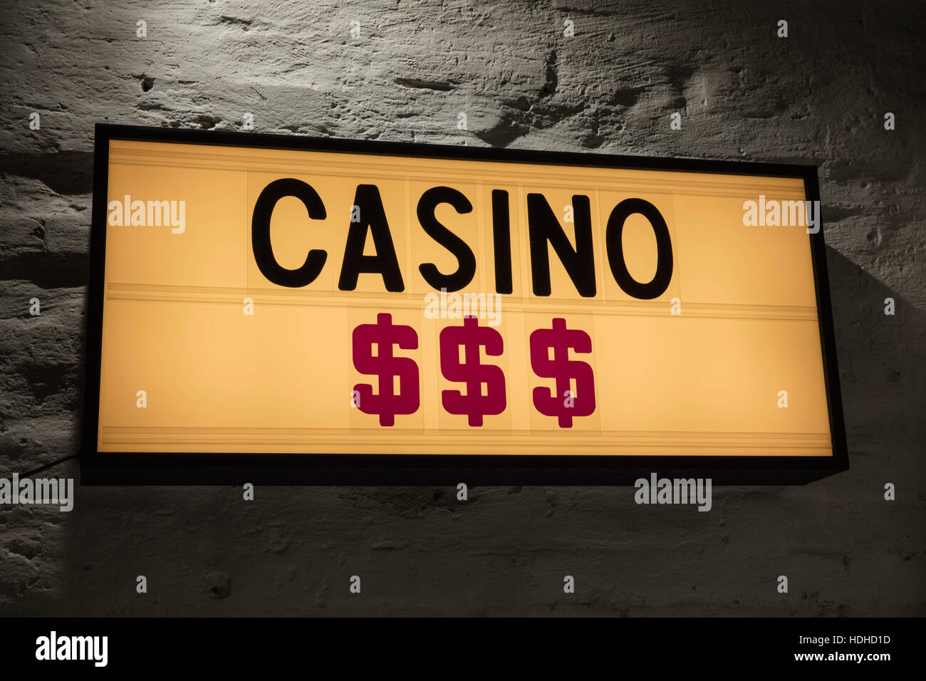 Close-up di casinò e di segni di dollaro cartello contro il muro grigio Foto Stock