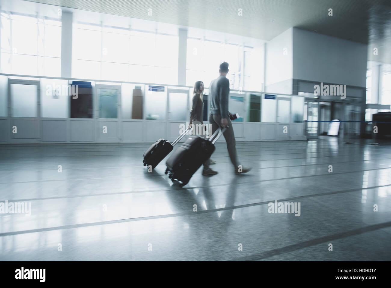 Coppia giovane con pochi bagagli in aeroporto Foto Stock