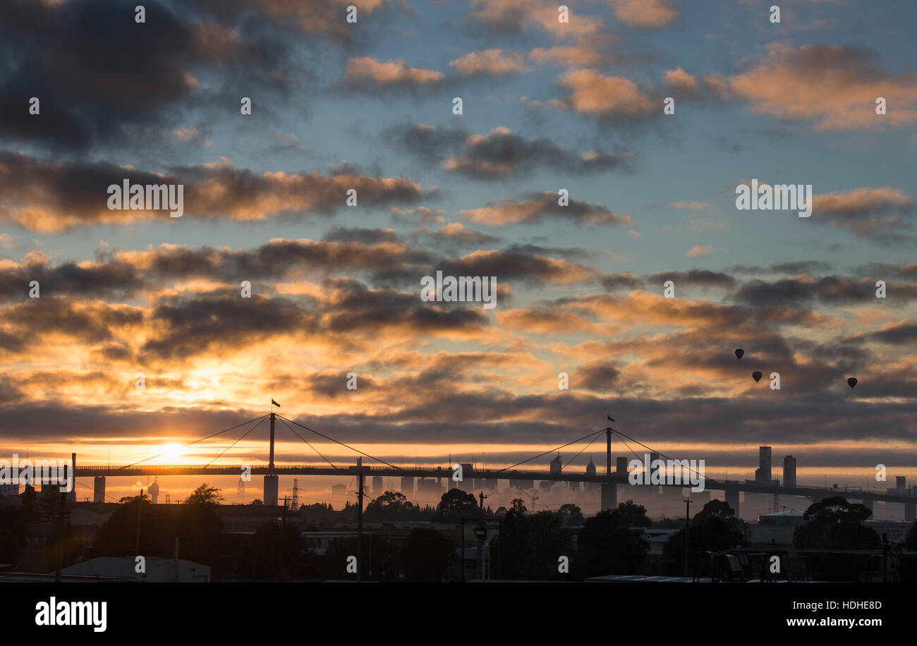 Vista del ponte e skyline contro il cielo nuvoloso durante il tramonto, Melbourne, Victoria, Australia Foto Stock