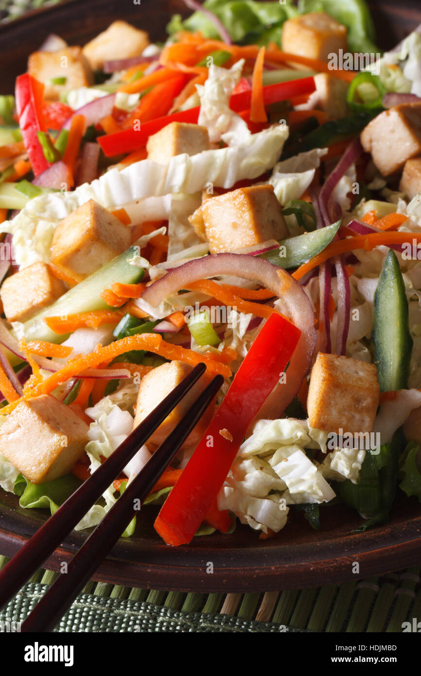 Una sana insalata con tofu e verdure fresche macro su di una piastra verticale. Foto Stock