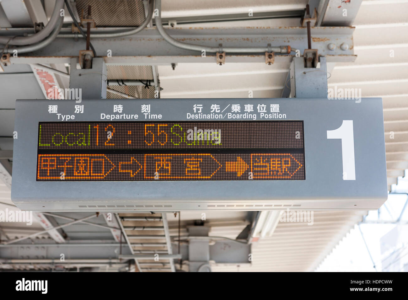 Giapponese overhead ferroviaria treno informazioni display segno per la linea di Kobe con in inglese il treno locale per la Suma arrivando a 12:55sulla piattaforma. Foto Stock