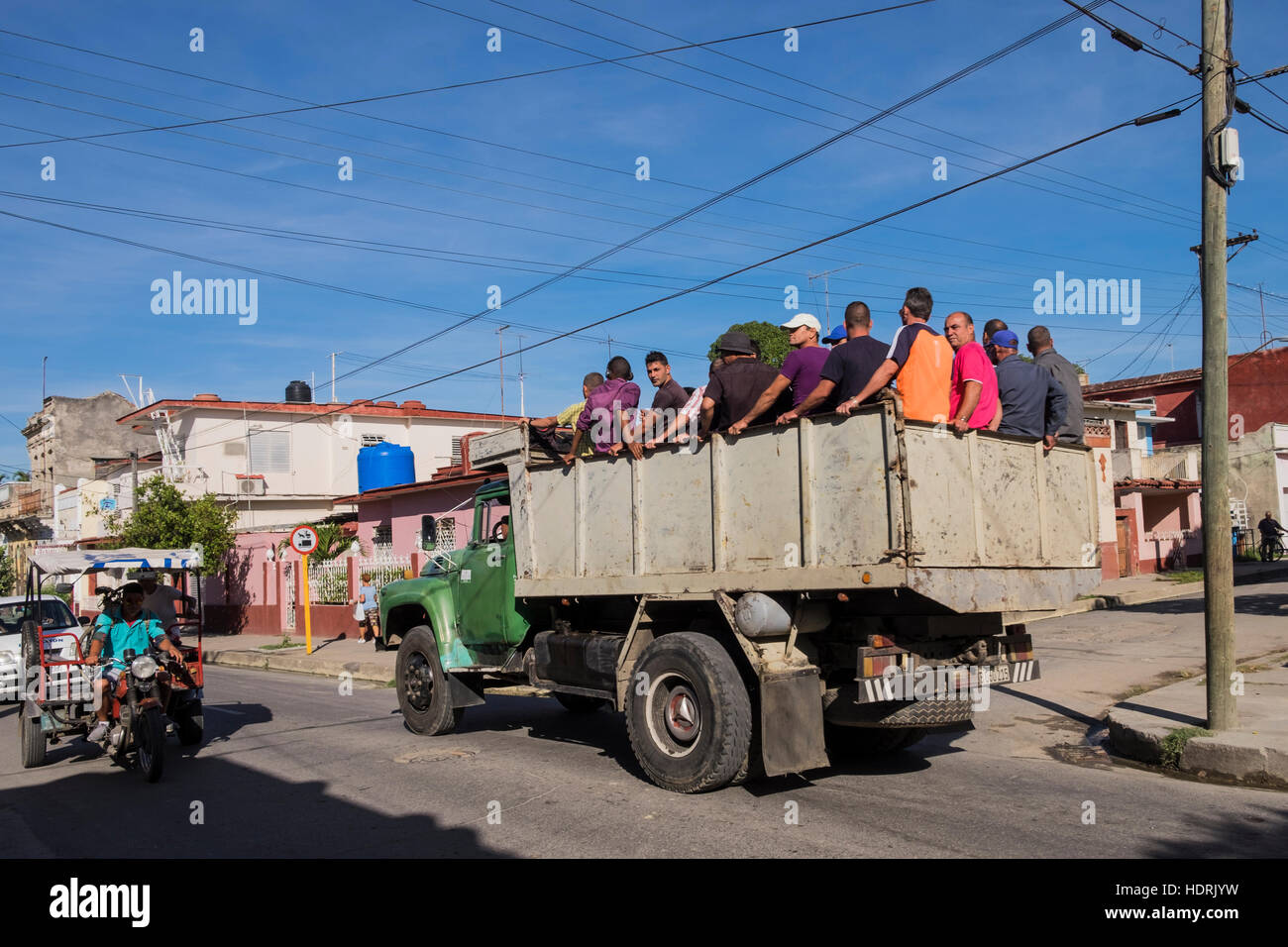 Gli uomini sulla parte posteriore di un camion per essere trasportati a lavorare, Cienfuegos, Cuba Foto Stock