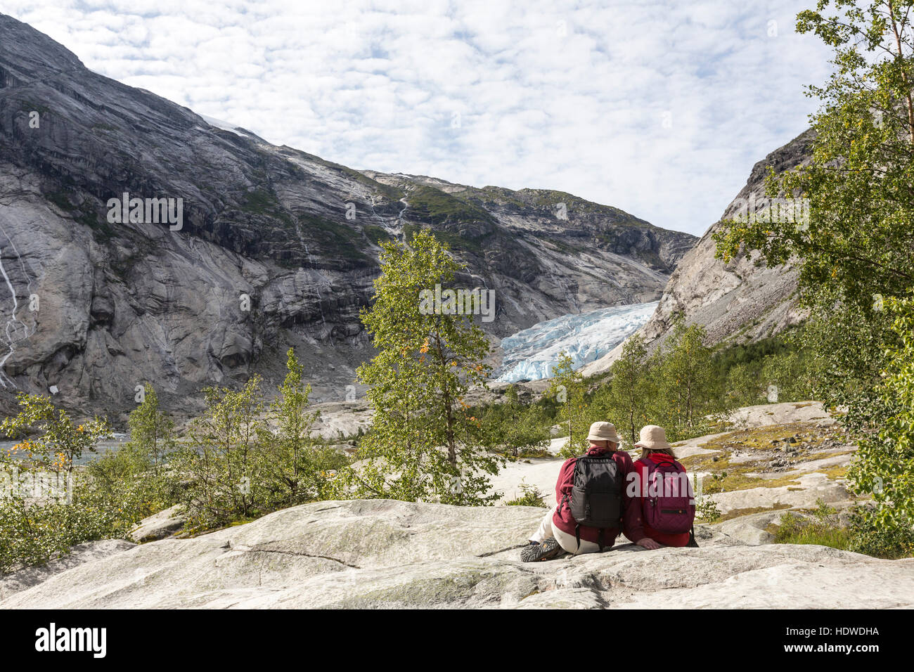 Coppia di turisti guardando Nigardsbreen glacier, Jostedalsbreen glacier. Gaupne, lucentezza, Sogn og Fjord Norway Foto Stock