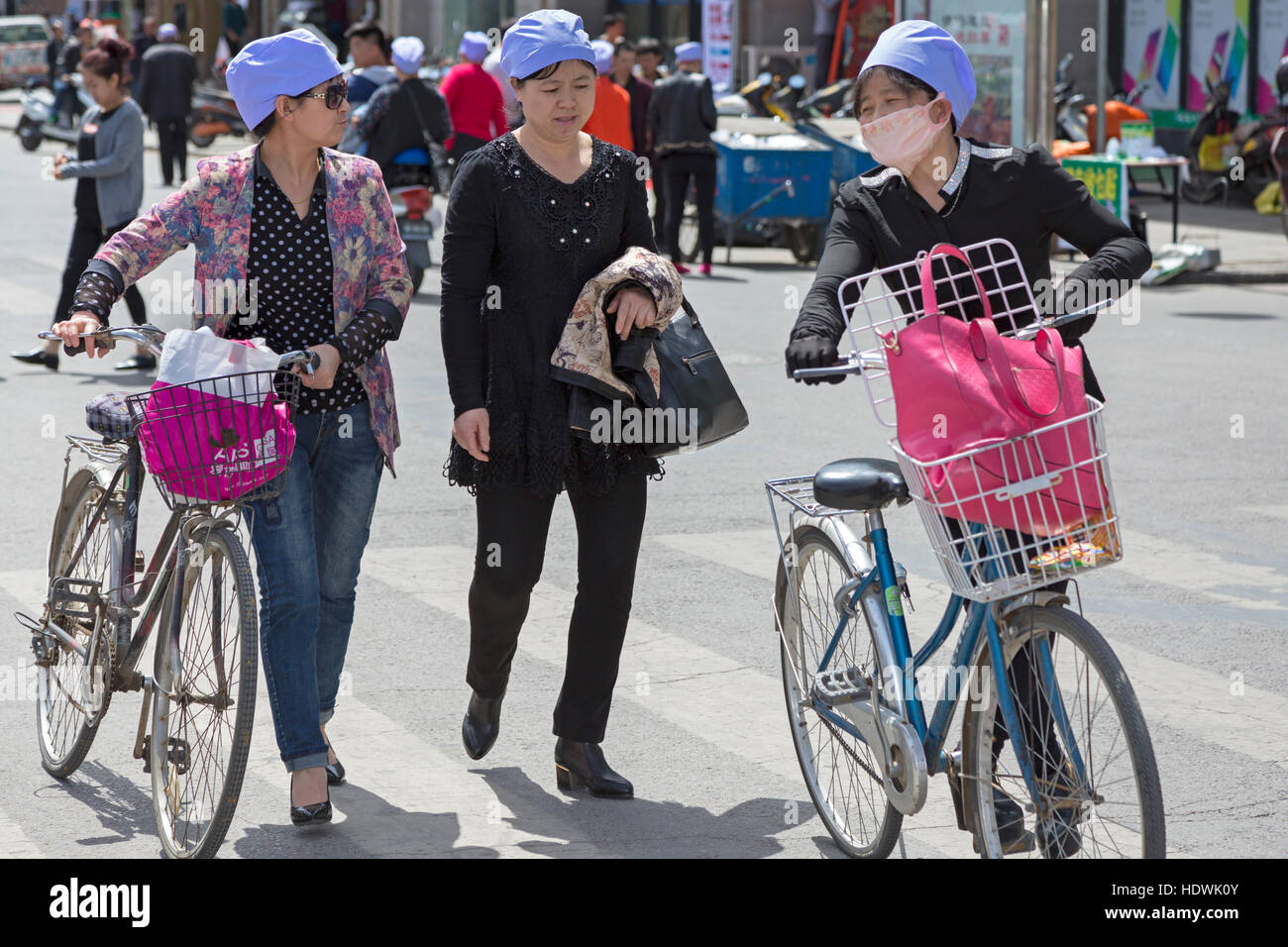 Hui donne a spingere le biciclette, Wuzhong, Ningxia, Cina Foto Stock