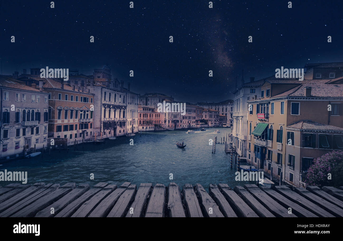 Arte immagine retrò con gondola sul Canal Grande di notte con listoni in legno pavimento per colore di primo piano e la luna piena e lattiginosa, Venezia Foto Stock