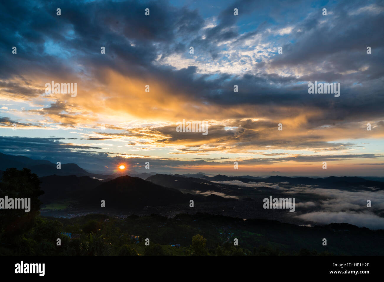 Vista su tutta una gamma di montagna, nelle vallate coperta di nebbia, di sunrise Foto Stock