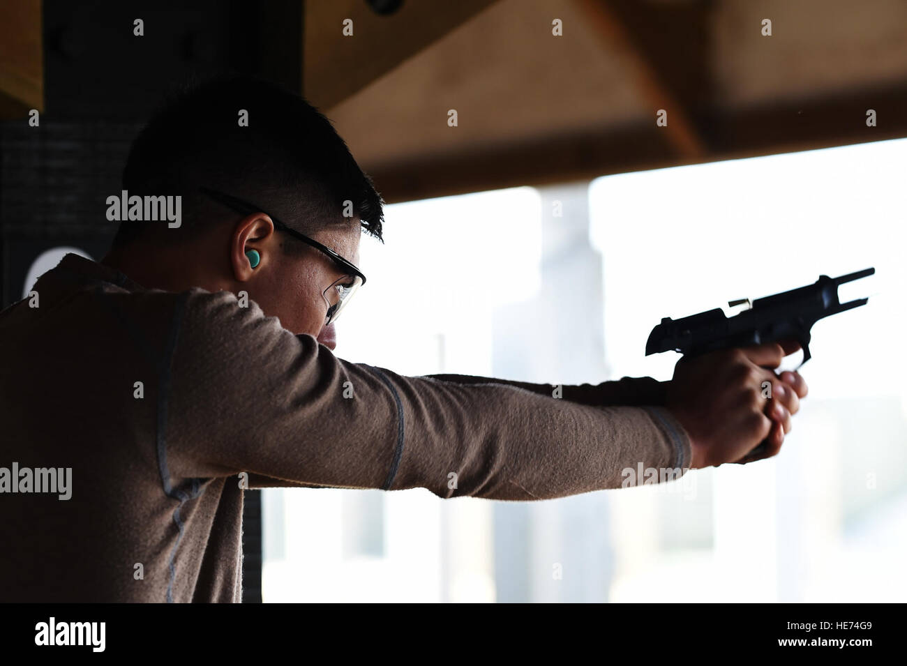 Senior Airman Kevin Sekishiro, 423rd delle forze di sicurezza Squadron patrolman, incendi di un round da un M9 pistola durante una polizia nazionale settimana concorso di tiro a RAF Molesworth, Inghilterra, 13 maggio 2015. Settimana di polizia è stato istituito in onore di funzionari di polizia che hanno dato la loro vita nella linea del dazio. Il personale Sgt. Jarad A. Denton Foto Stock