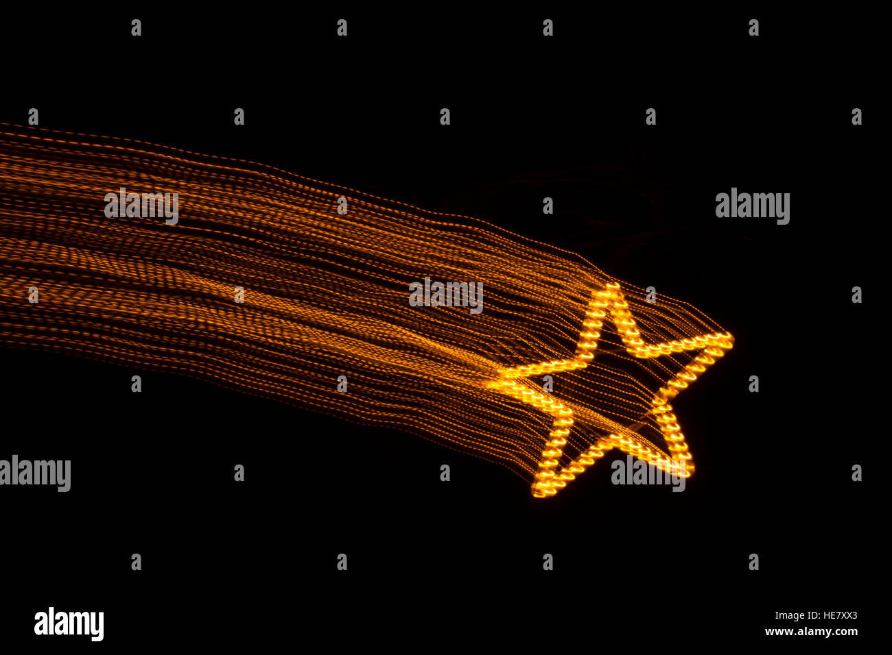 A forma di stella di Natale decorazione a forma di stella cadente dalla luce della pittura. Foto Stock