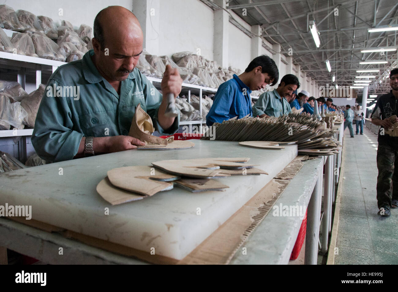 100916-F-1020B-017.jpg Kabul - Lavoratori a Kabul Milli Trading Company Montaggio in fabbrica stivali da combattimento per l'Esercito nazionale afgano sett. 16, 2010. La fabbrica fa circa 2.400 stivali al giorno e dopo il lavoro con la NATO Training Mission - Afghanistan consulenti, ha notevolmente migliorato la qualità di scarpe prodotte. Il personale Sgt. Sarah Brown/) Foto Stock