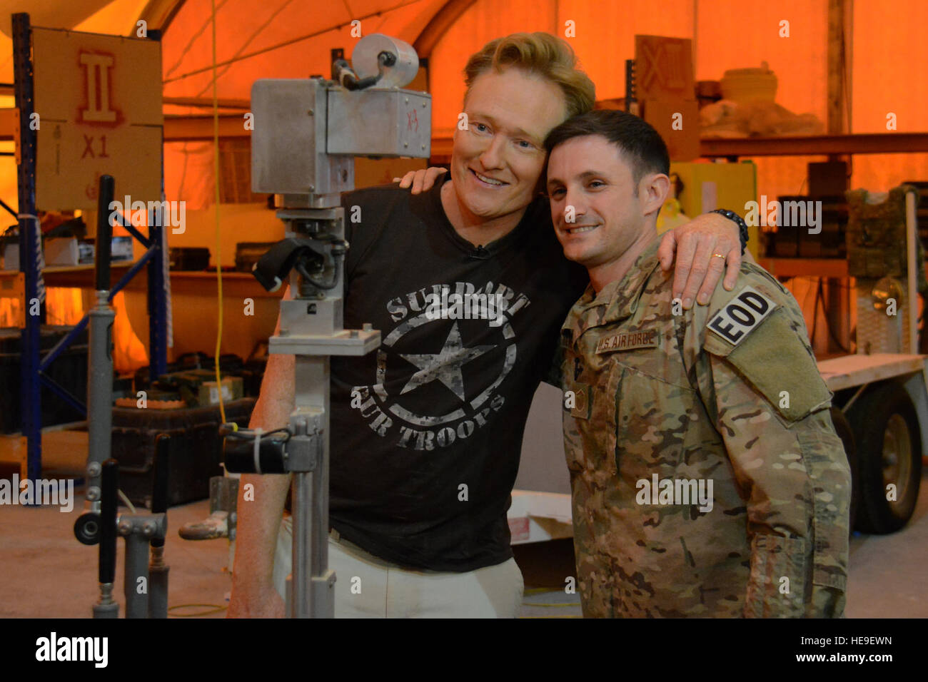 Late Night talk show host e il comico Conan O'Brien in posa per una foto scattata dal EOD robot F-6 con Master Sgt. Bradley Kline, 379 Expeditionary ingegnere civile Squadron l'eliminazione degli ordigni esplosivi volo capo sezione, durante una visita a Al Udeid Air Base, Qatar, nov. 4. Durante la sua visita, O'Brien ha messo in uno spettacolo di varietà per servizio distribuito di membri e li ha ringraziati per tutto ciò che essi fanno per difendere l'America. Tech. Sgt. James Hodgman Foto Stock