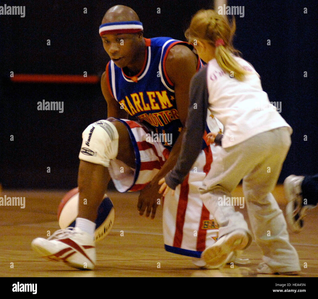 Harlem Globetrotter 'Sweet Pea' cerca di mantenere il basket lontano dal pubblico gli Stati Cailynn Smith durante una partita di basket Dic.1a il drago Centro Fitness presso la base aerea di Aviano, Italia . Gli Harlem Globetrotters sono touring Esercito e forza dell'aria impianti in tutta Europa come parte della loro 'Magic come mai' 2008 world tour. (US Air Force foto/Airman 1. Classe Ashley Wood) Foto Stock