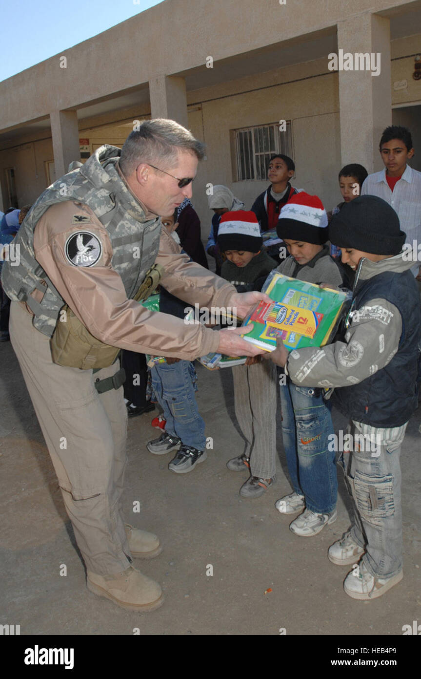 Stati Uniti Air Force Col. Matteo Dorschel, comandante di 407 Aria Gruppo Expeditionary, mani di forniture scolastiche per i bambini presso la nostra scuola elementare al di fuori di Ali Air Base, Iraq, Febbraio 3, 2008. Le scuole e le altre organizzazioni attraverso gli Stati Uniti hanno donato le forniture. Tech. Sgt. Sabrina Johnson) Foto Stock