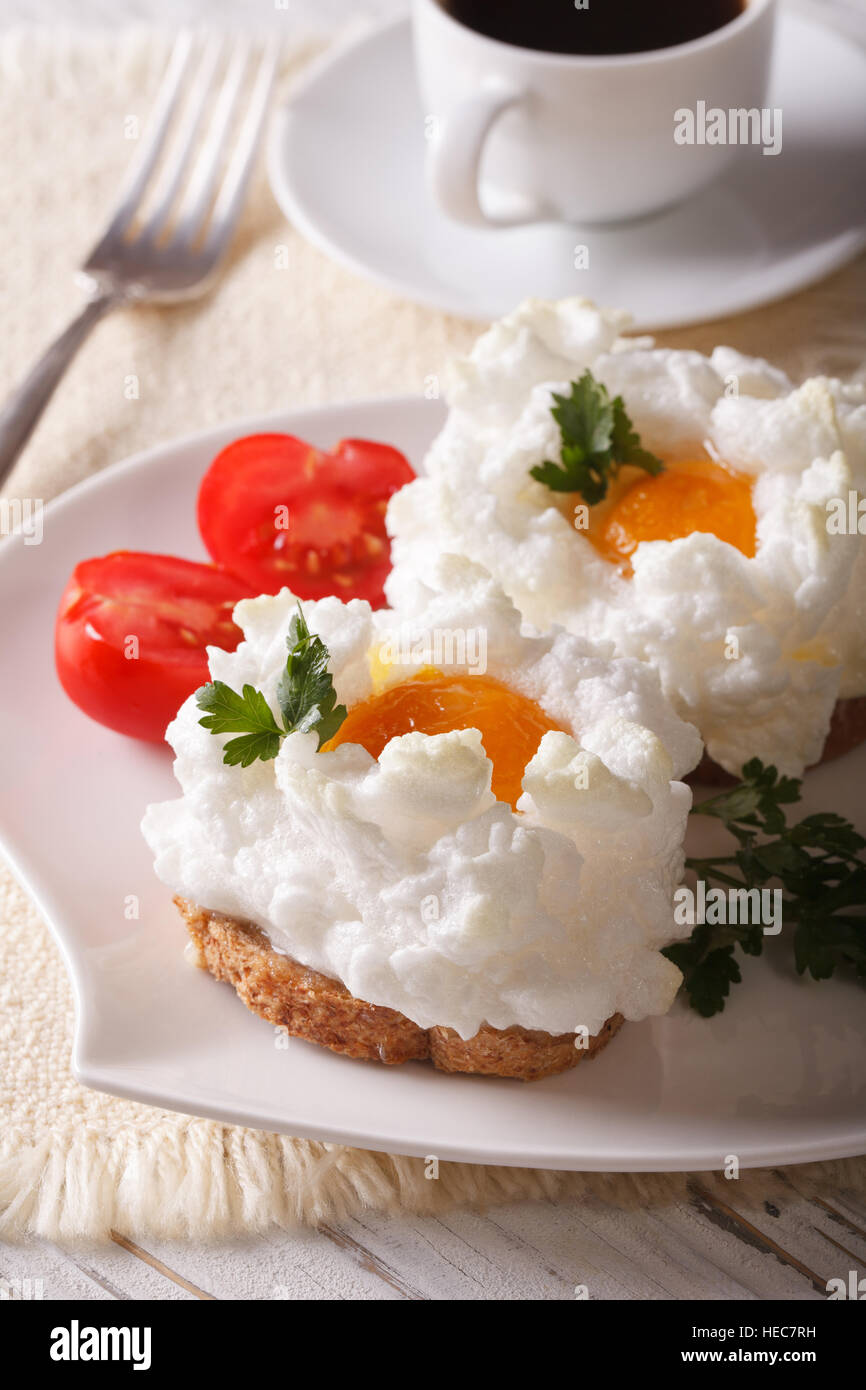 La colazione aristocratica: panini con uova cotte Orsini e pomodoro su una piastra di close-up verticale. Foto Stock