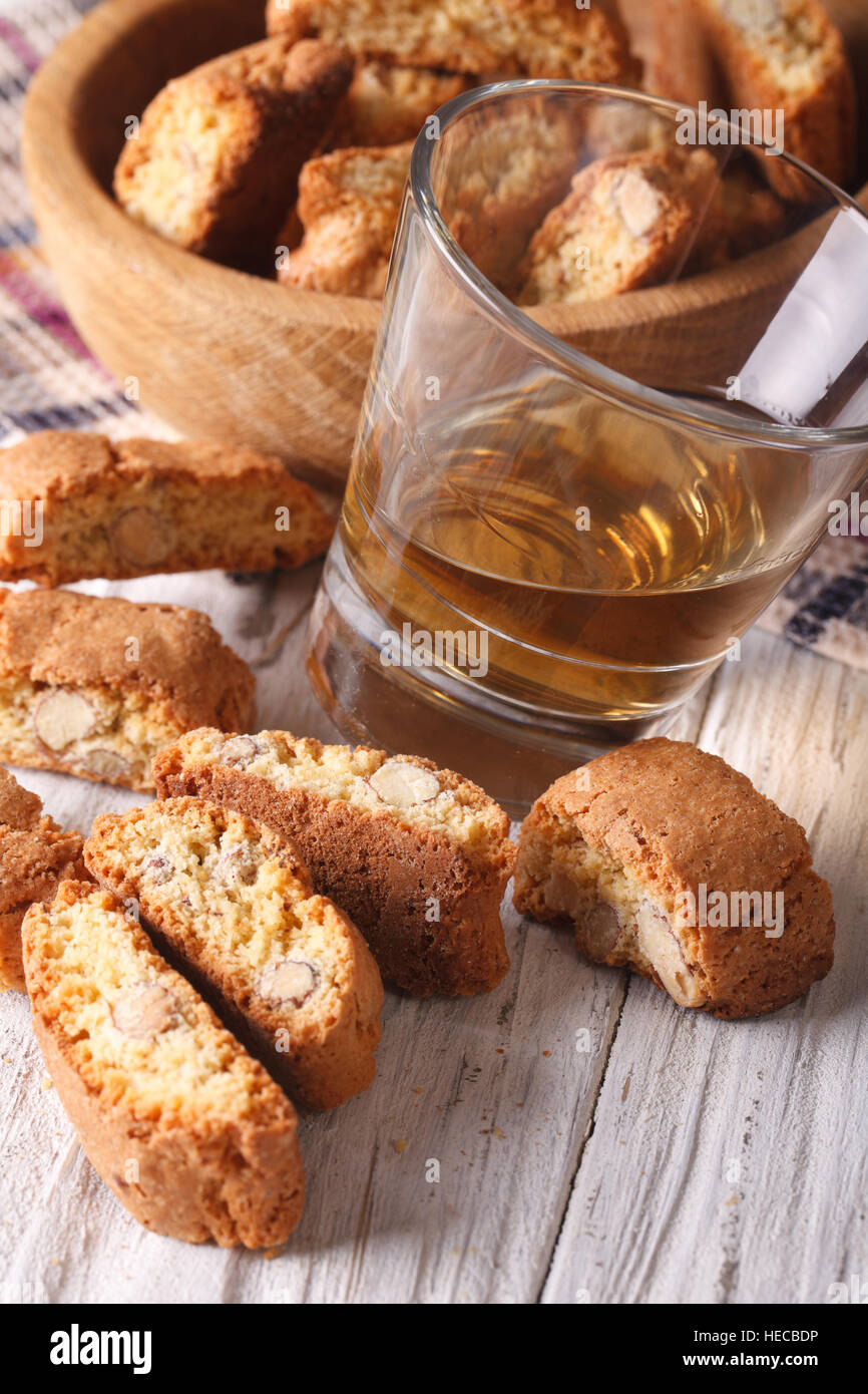 Italiana mandorla biscotti biscotti e vino vicino sul piano verticale. Foto Stock