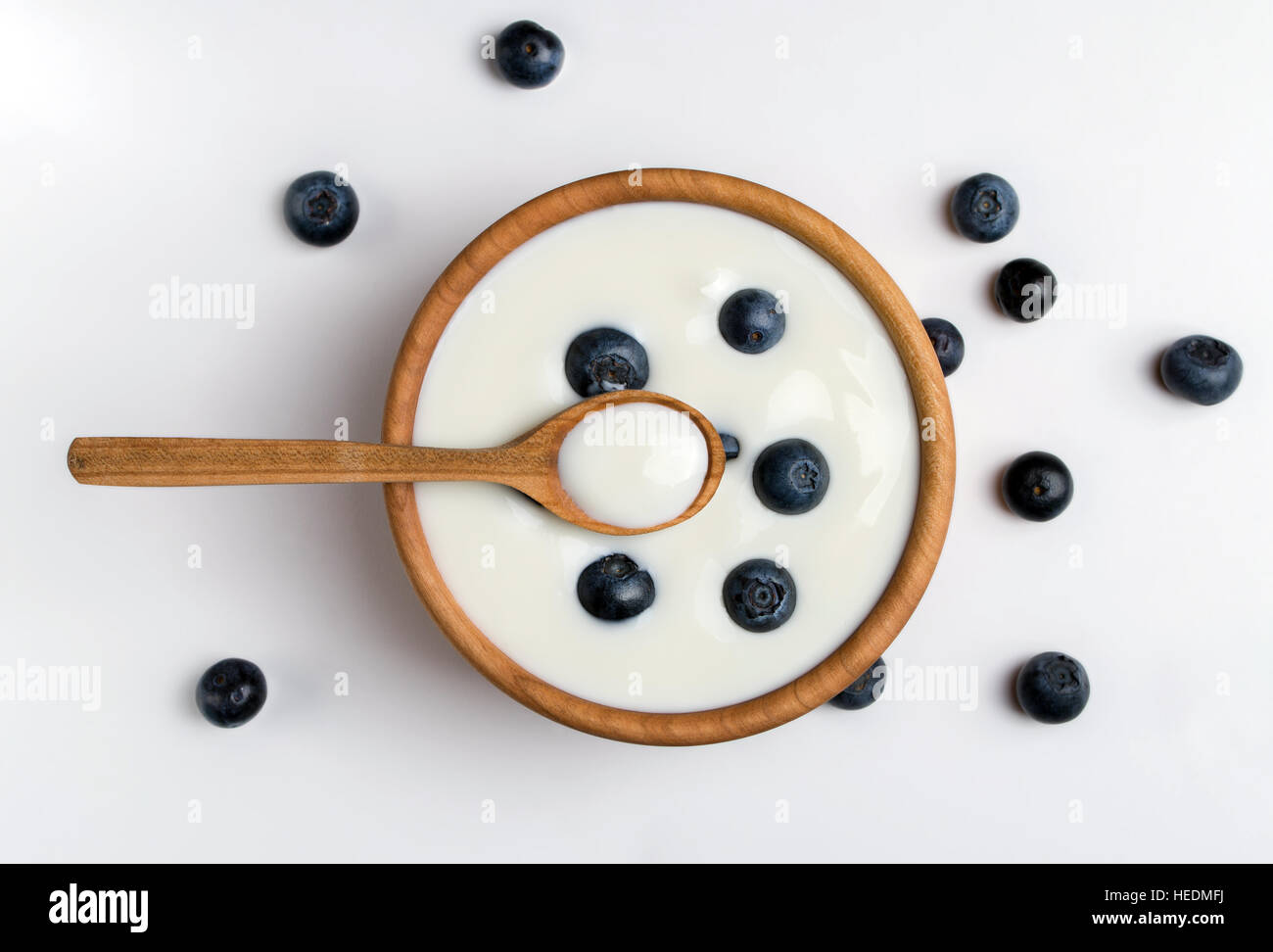 Yogurt bianco naturale e in ciotola di legno con mirtilli. Vista dall'alto. Foto Stock